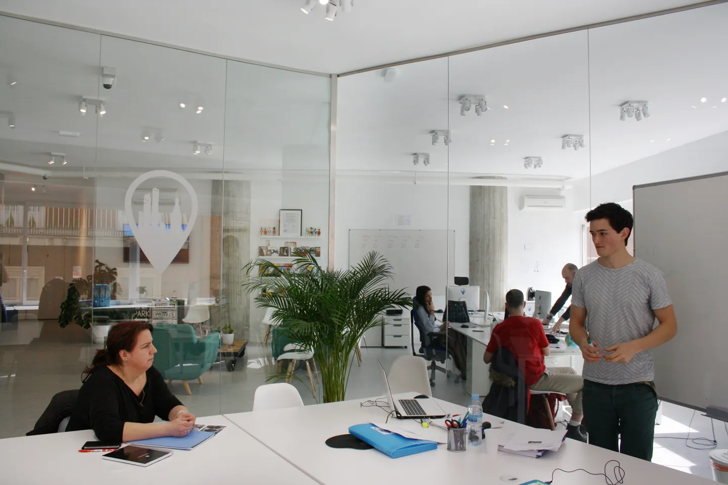 An Exam Madrid Academy classroom with study tables and glass walls.