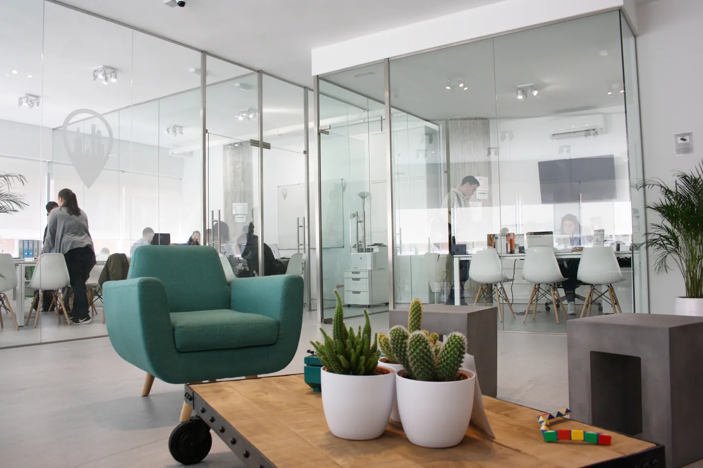 Lounge area and glass-walled classrooms at Exam Madrid Academy, Madrid.